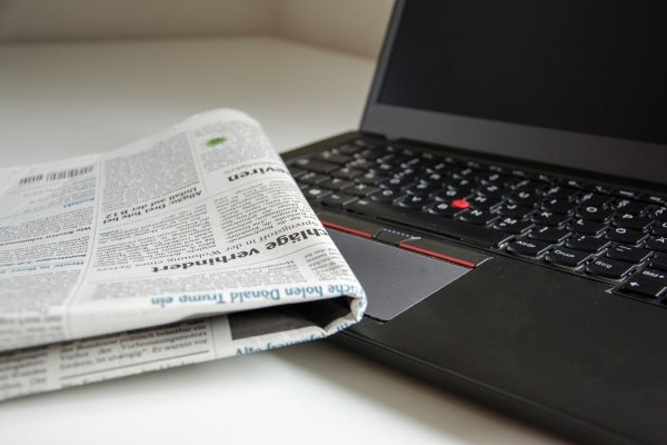 laptop and newspaper image