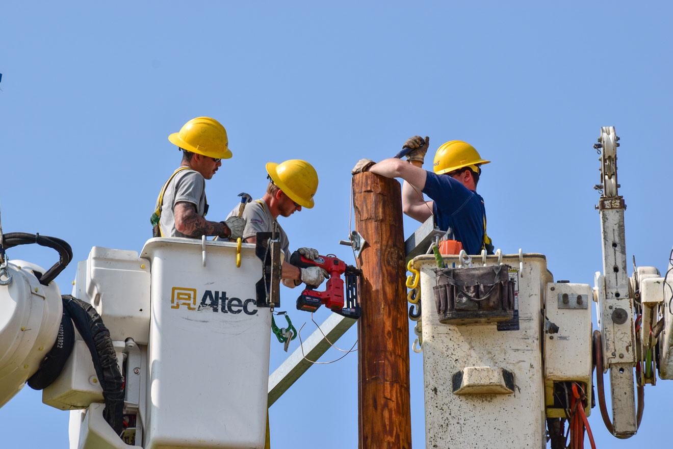 Linemen in two bucket trucks