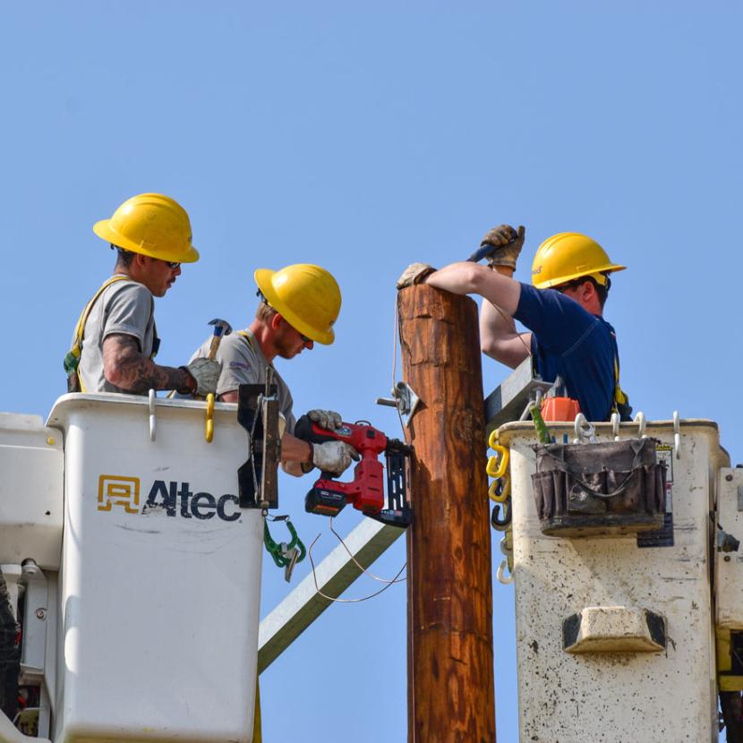 Linemen in two bucket trucks